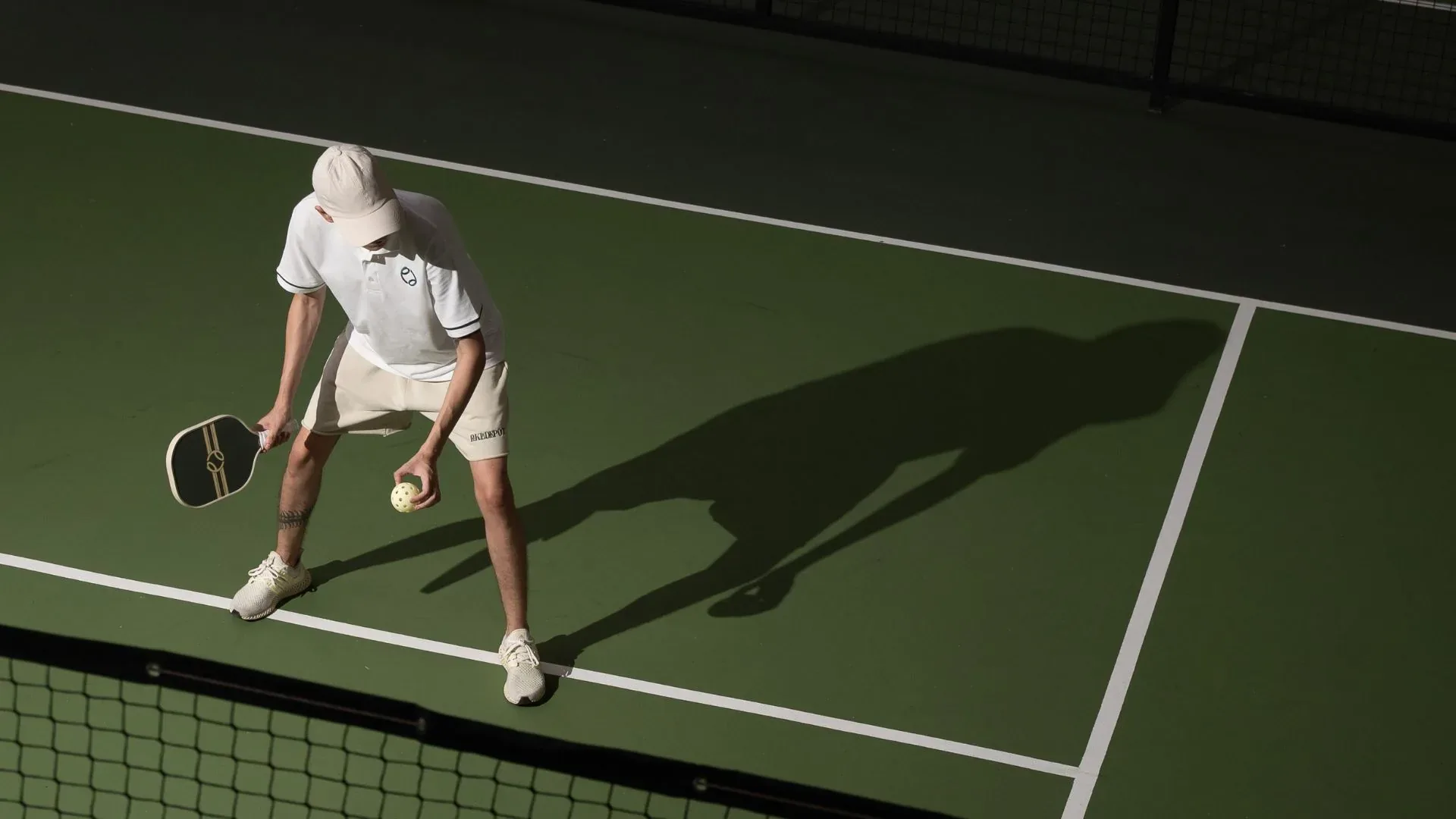 Player preparing to serve on a PickleDepot court